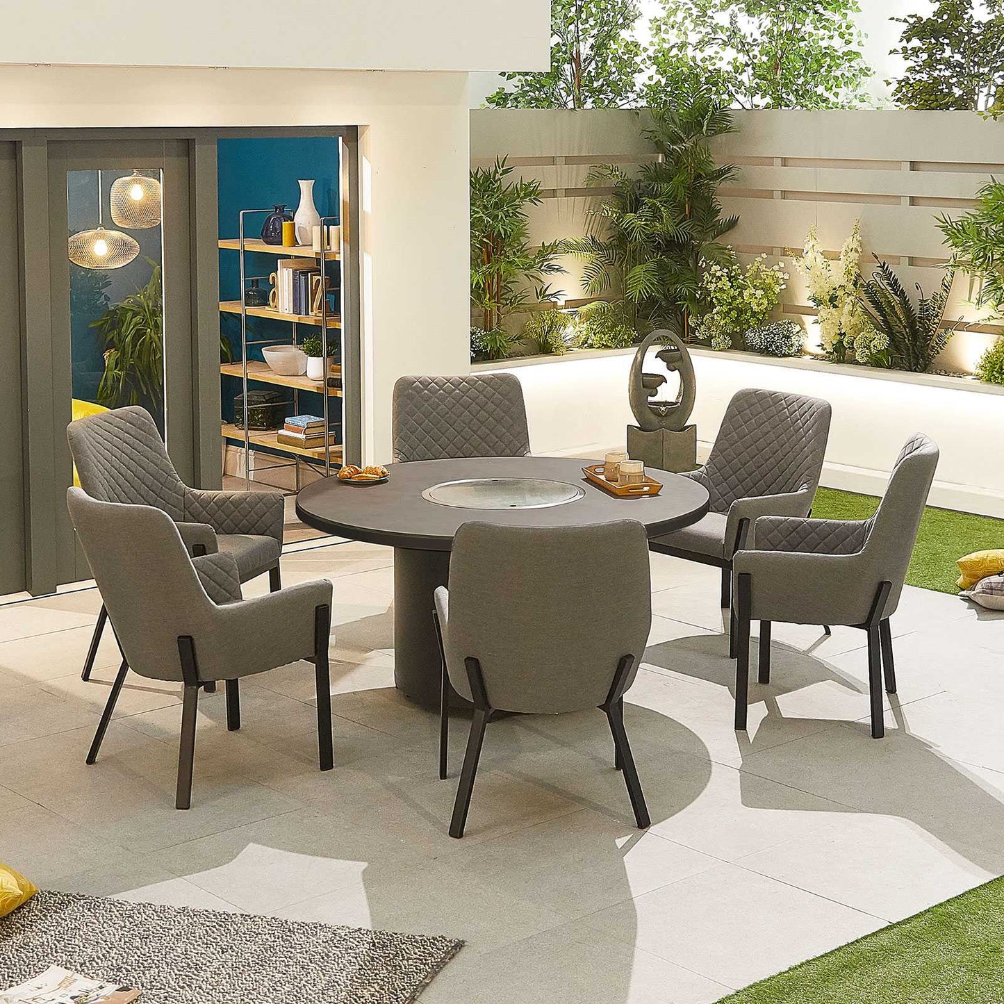 Six light grey modern chairs and dark grey circular table